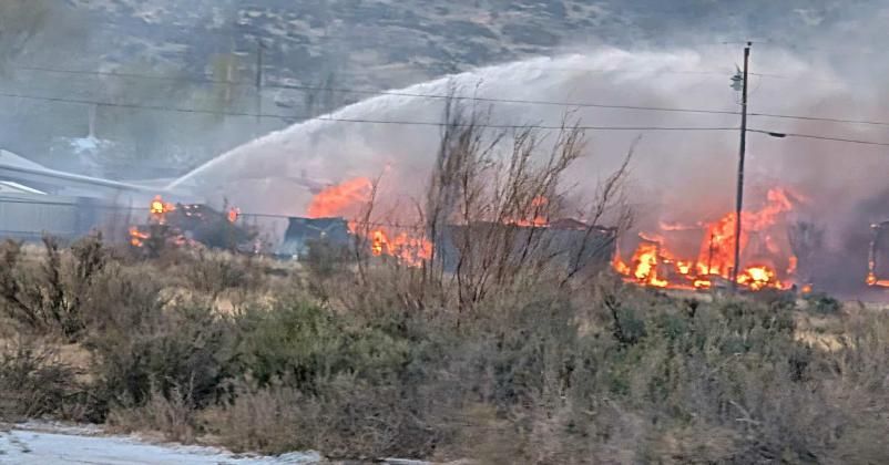 Flames engulf multiple homes Sunday evening in the Balsam/Sage area of Grants as firefighters battle the fast-moving Alamo Fire. The blaze destroyed six homes and injured two firefighters before it was fully extinguished later that night. Photo by Patrick Gonzales