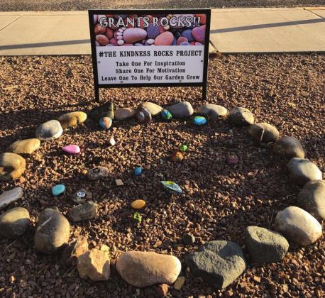 Community members adding more decorated rocks