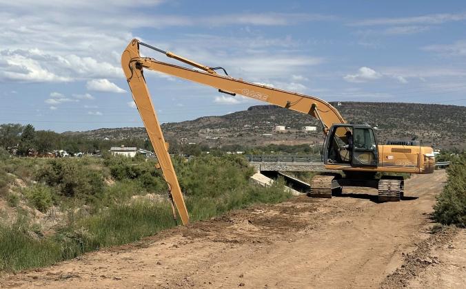 City of Grants employee Brian Smith operates a longreach excavator along the Rio San Jose near the George Hanosh Bridge. Smith, who has worked for the city for 15 years, said operating the equipment safely requires experience and careful attention to the machine’s limits. Diego Lopez - CC