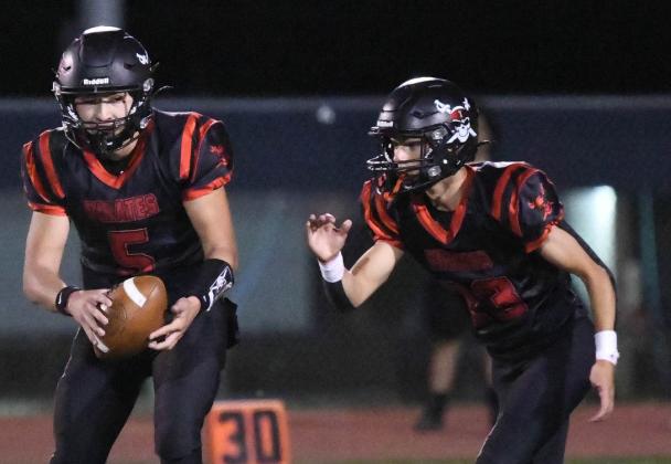 Let's Go! GHS quarterback Trisitin Fernandez, 5, readies himself to hand off the ball to Joe Clawson, 23, this past Friday at the Port of the Pirates as the Pirates hosted the Aztec Tigers. The Pirate defeated the Tigers 28-6. Franklin Romero - CC