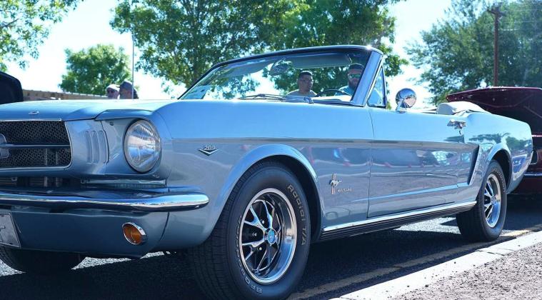 A beautifully restored classic Mustang convertible gleams in the sun during the Spokes on 66 Car Show, drawing admiration from car lovers up and down historic Route 66. Diego Lopez - CC