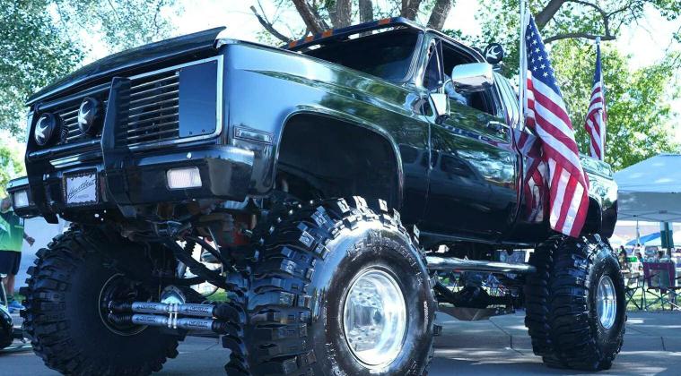 A lifted black Chevy truck proudly flies American flags at the Spokes on 66 Car Show in downtown Grants, drawing crowds with its bold stance and patriotic flair. Diego Lopez - CC