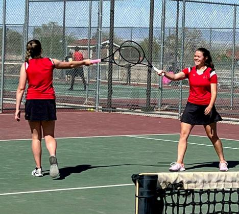 Karysn Cash and Alexia Munson celebrate a set winning shot against Belen. Photo Credit April Cash