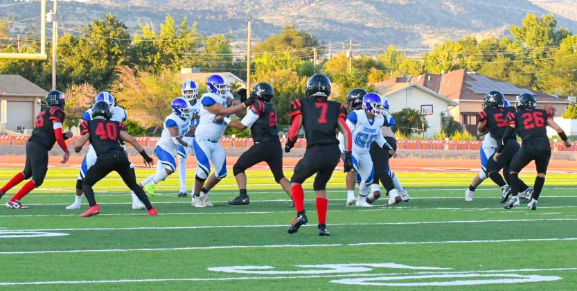 The Grants High School Pirate football team fell to the Espanola Valley Sundevils this past Friday in a close road game. The final score was 14-7 and the Pirates drop to 1-3 as they travel to Kirtland Central High School (1-3) this upcoming Friday. In this file photo from a recent home game the Pirates defense move in on the Dexter Demons offense. Franklin Romero - CC