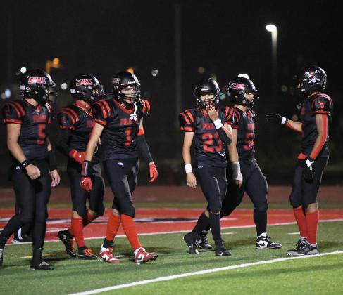 Grants Pirates huddle up during a Friday night showdown. The Pirates, currently 3-3 overall and 2-1 in district play, are preparing to face the Taos Tigers in a key district matchup on October 11 at the Port of the Pirates. Franklin Romero - CC