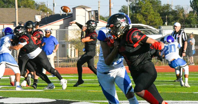 Quarter back Tristin Fernandez, 5, lets a pass fly this past Friday at the Port of the Pirates. The Pirates lost to the Dexter Demons by a score of 34-12. Franklin Romero - CC