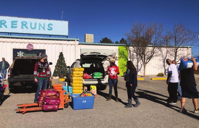 Amanda Young and Nathan Mullins tend to community needs, giving away one bag of cat or dog food per household. Kylie Garcia - CC