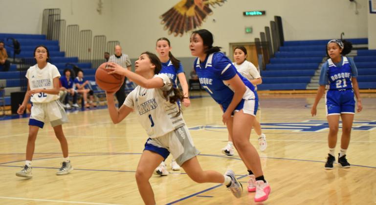 Lady Hawks are currently 3-2 after a couple of recent wins. The defeated East Mountain 5718 and won a close game against Moriarty 45-42. They will play the Lady Panthers of Menaul (2-3)on Tuesday, December 12 at home. In this photo Kaylee Lorenzo (1) drives it in to the hole for a bucket against East Mountain.