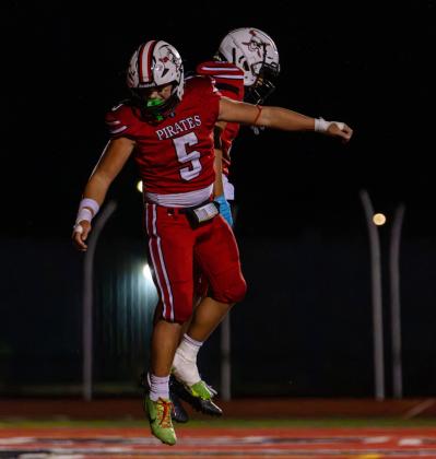 Julian Fernandez, sophomore, celebrates with teammate Elijah Marquez following a Pirates play. Jay Langford- Student Journalist