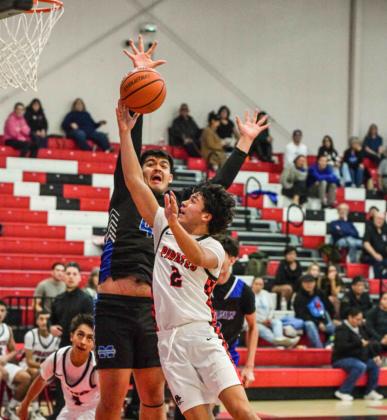 The GHS boys basketball team went 1-1 in their last 2 games. The Pirates lost to St. Michaels, 74-62, then traveled to Gallup and defeated the Bengals 55-48 on their home court. In this photo senior Coudy Melonas, 2, drives it in for a bucket against a St. Michaels defender. Franklin Romero - CC