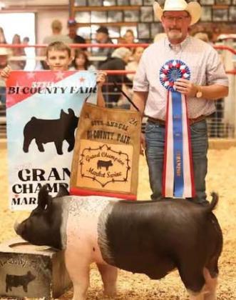 Bryce Hanson stands with his Grand Champion Market Swine during the 57th Annual Cibola-McKinley Bi-County Fair in Prewitt. Courtesy Photo