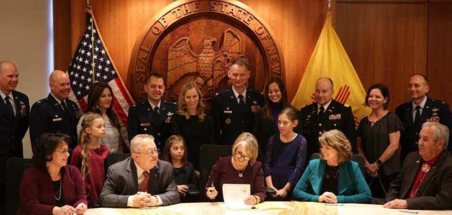 Representative Eliseo Alcon is pictured with New Mexico Governor Michelle Lujan Grisham as she signs HB 30 Expedited Licensure for Military Families and Veterans on Feb. 26, 2020, at the state capitol in Santa Fe, N.M. Alcon played a key role in advocating for the legislation, which supports reciprocity and eases occupational licensing for military members, veterans, and their families. Courtesy of U.S. Air Force photo by Jim Fisher