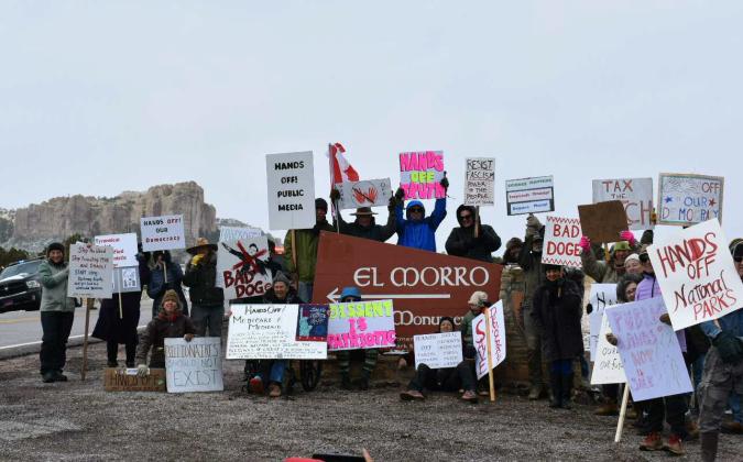 An expression of free speech, these protestors marched from the Old School Gallery to the El Morro National Monument in the Zuni Mountains to protest the President of the United States and his administration. The group peacefully marched to express their First Amendment rights to redress their government, carrying USA, Canadian, and pride flags. Courtesy Photos