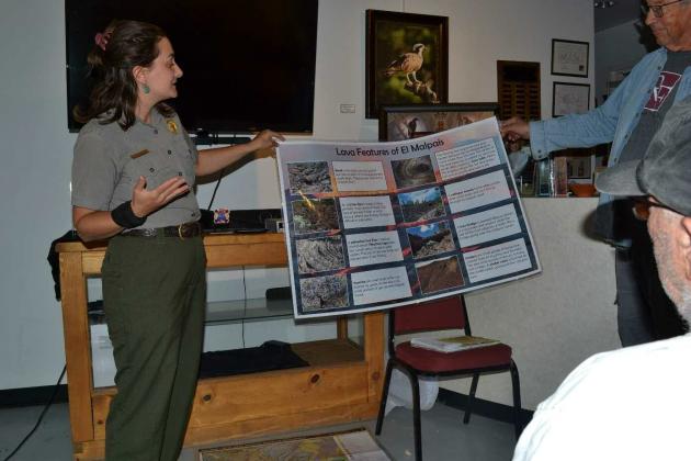 El Malpais National Monument Park Ranger, Carly Monnin displays illustrations of volcanic ecosystems and biodiversity. Kathryn Marmon - CC