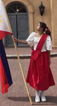 Cabotaje holds the Philippine flag during the 2024 Santacruzan, symbolizing national pride and heritage. Courtesy Photo