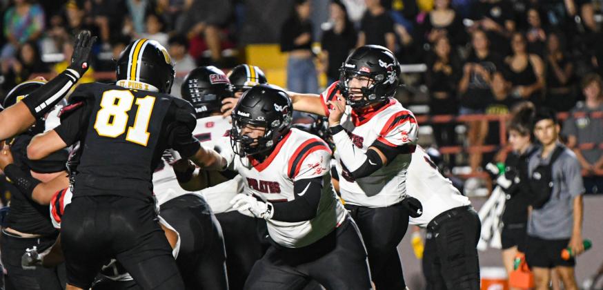 Quarter back Tristin Fernandez, 5, able to get a pass off just as the St. Pius defense closes in. The Pirates lost 407 in their first road game of the season last week. They are currently 1-1 and will face Dexter High School this Friday at home. The Demons came in at 2-0. Franklin Romero - CC