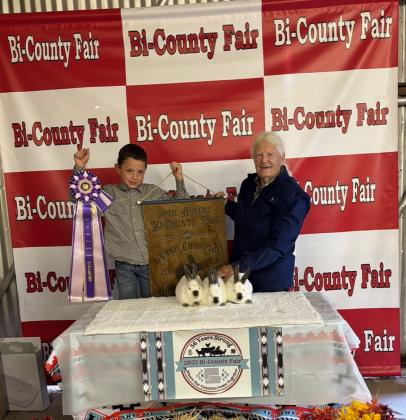 Luke Branum with the Grand Champion Rabbit Meat Pen Courtesy Photo