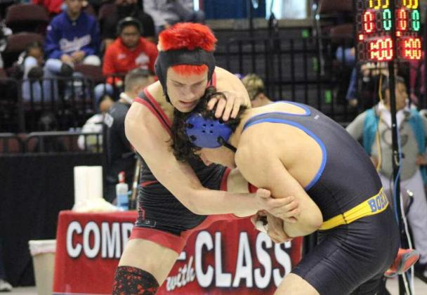 Larry Meador, a junior, wrestling at the 145-pound weight class battles it out at the state tournament. Franklin Romero - CC