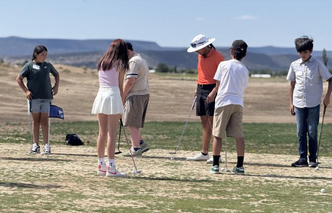 Young golfers gather at the Coyote Del Malpais Golf Course in Grants for the annual Kids 4 Golf Clinic, hosted by staff and volunteers to teach the fundamentals of the game and share a love of the sport.