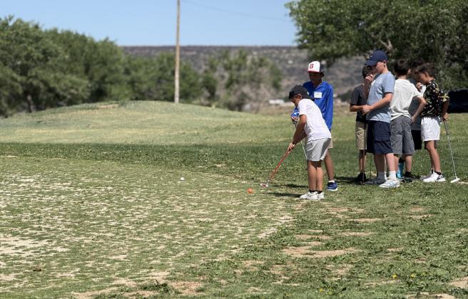 Young golfers gather at the Coyote Del Malpais Golf Course in Grants for the annual Kids 4 Golf Clinic, hosted by staff and volunteers to teach the fundamentals of the game and share a love of the sport.