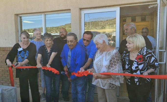 Village of Milan current and former trustees cut the ribbon announcing the grand opening of the new village hall. Arieanna Crowson - CC