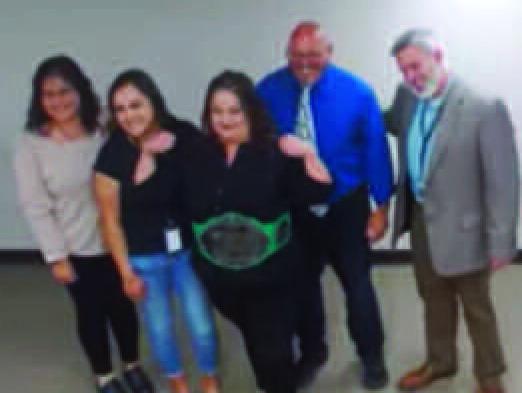 Ms. Monica Vallejos from LAHS, with the Educ Champion Belt, LAHS principal Mr. Jackie Sanchez, and Superintendent Mr. Lane Widner. Photo courtesy youtube.com.