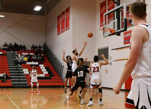 Senior Nicholas Miera, 10, with a lay-up as teammates look on at a recent game against the Belen Eagles at the Port of the Pirates. Franklin Romero - CC