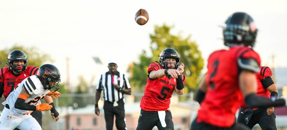 Boom on point! Tristin Fernandez, 5, quarterback for the Pirates with a bullet to Cardenio Chavez, 2, last week in a tight game against the third ranked Taos Tigers. The Pirates strong defense and on point offense defeated the Tigers 21-19. Franklin Romero - CC