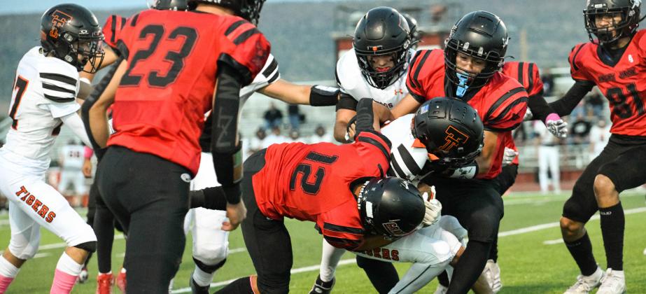 Julian Fernandez, 12, with teammates on a big tackle this past Friday against the Taos Tigers. The Pirate defense was very instrumental in the defeat of the 3rd ranked team in 4A football, the Taos Tigers. 'Our defense played very well,' said GHS head football coach Steve Brown. Franklin Romero - CC