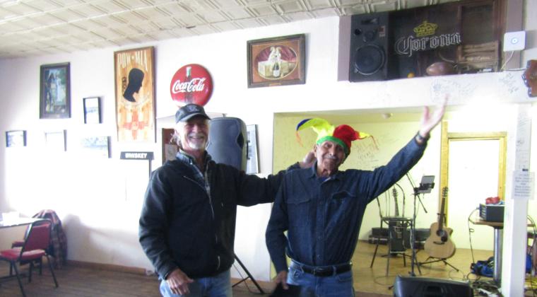 Johnny Montoya (l) accepts his All Fool's Day jesters hat. Photo by Roger Siegmann