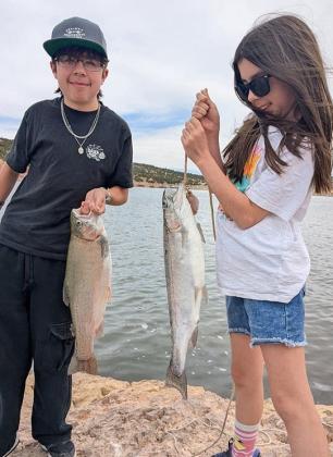 Vicente and Victoria Parra caught a 22-inch trout and a 21-inch trout, respectively, using Orange Glitter Power-Bait on May 24. Courtesy Photo