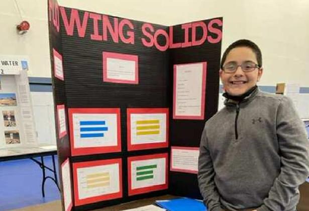 Aaden Jiron, a student at St. Teresa of Avila Catholic School in Grants, looked at whether granular materials could flow faster than water. Courtesy Photo