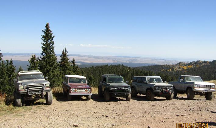 Broncos lined up near Mt. Taylor summit with Colorado mountains in the background Photo by Roger Siegmann