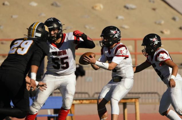Grants High School quarterback Tristin Fernandez, 5, with a handoff this past Saturday at Milne Stadium in a 4A semi-final game against St. Pius Franklin Romero - CC