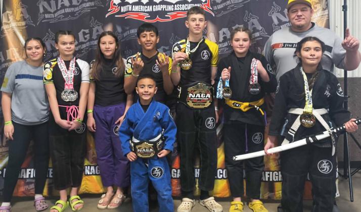 Joey 'JoJo' Lujan surrounds himself with his professor and father Joey Lujan and teammates after winning his gold medal in no gi. Lujan also won a 1st place belt in gi. Franklin Romero - CC