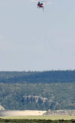 A helicopter prepares to draw water from Bluewater Lake on Aug. 10 while supporting suppression efforts on the Four Mile Fire in the northwest Zuni Mountains. The fire was burning south of Jamestown and Interstate 40, southeast of Fort Wingate and north of McGaffey. Photo By Kathy Helms