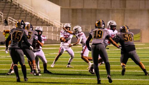 Quarter back DJ Chavez,0, with a handoff last Friday at the Nusenda Community Stadium where the Pirates squared off with the Sartans in the 4A football quarterfinals. The Sartans defeated the Pirates 48-7. Franklin Romero - CC