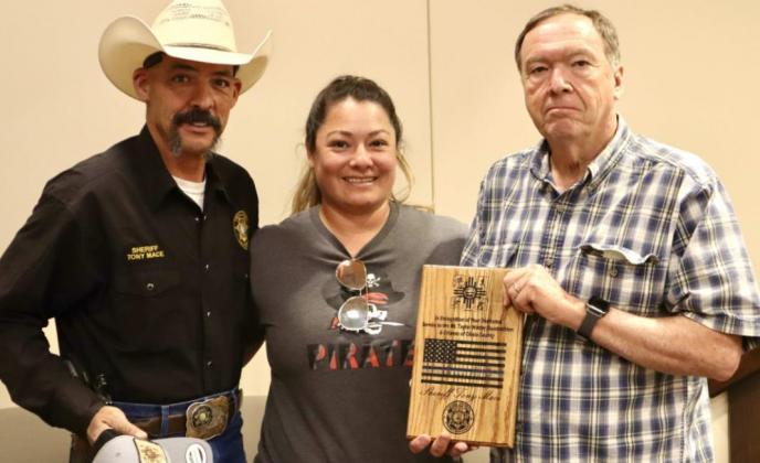 Quadrathlon organizers Les Gaines (right) and Stephanie Gaines (middle) present Cibola County Sheriff Tony Mace (left) with a plaque and hat in recognition of his dedicated service to the Mt. Taylor Winter Quadrathlon and citizens of Cibola County. Kylie Garcia - CC