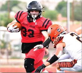 Outta my way! Douglas Mitchel, 33, a sophomore running back, breaks through the Gallup defense last week in the Grants High School homecoming game. The Pirates defeated the Gallup Bengals 56-0 and advance to a 1-1 record. Franklin Romero - CC