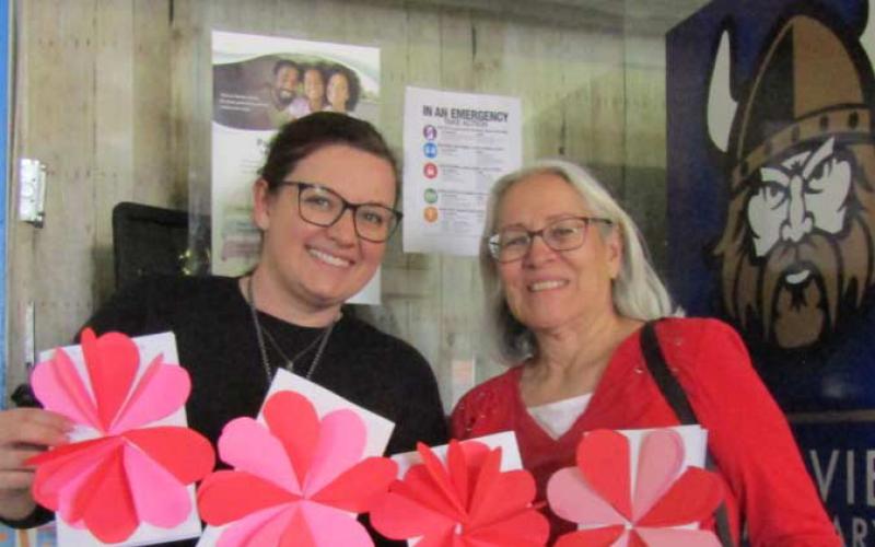 Kayla Brownfield (Vice Principle, on left) from Mesa View Elementary presenting Valentine cards created by their students to Evelyn Siegmann Courtesy Photo