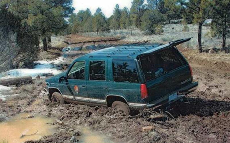 SUV stuck in the mud on County Road 42. Photo by NPS