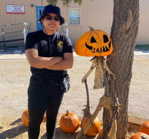 Ramah Navajo Police Department Officer Yazzie poses with a pumpkin display during the Pinehill Wellness Center’s Pumpkin Carving Event on Oct. 29. The event, supported by RNPD, the Cibola County Sheriff’s Office, and Miss Eastern Navajo Queen, brought families together for a day of creativity and community fun. Courtesy Photo