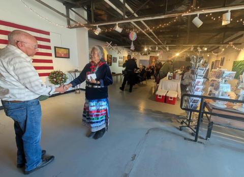 State Representative Martha Garcia of Pine Hill greets a local veteran during Monday’s Veterans Day luncheon at the Double Six Art Gallery in Grants. The event, hosted for area service members, featured patriotic art and floral arrangements created by Grants FFA students. Shiloh Simonson - CC