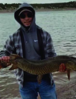 Gabriel Figueroa (above right) caught a 48-inch tiger muskie using Garlic PowerBait on April 15. “Surprisingly, I caught him with 10-pound mono, a No. 6 hook and PowerBait,” he said. “I fought him for four minutes before I got him on shore.” Courtesy Photo