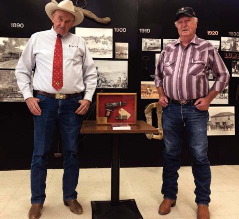 Diego Lopez - CC Don Bullis (left) presents the Cibola County Historical Society with the firearm believed to have been used in the Budville murders of 1967.