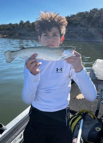 Elias Maes holds up one of his rainbow trout after reaching his limit on April 26 at Bluewater Lake. Kastmasters and Rapalas proved to be the winning combination for this successful morning outing. Courtesy Photo