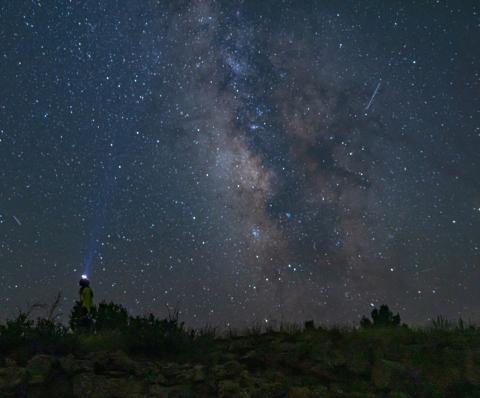 A stargazer looks toward the heart of the Milky Way at El Malpais National Monument, where pristine dark skies offer a window into the cosmos. April Astronomy Month programs invite the public to experience the wonders of the night sky with ranger-led events throughout the month. Courtesy Photo