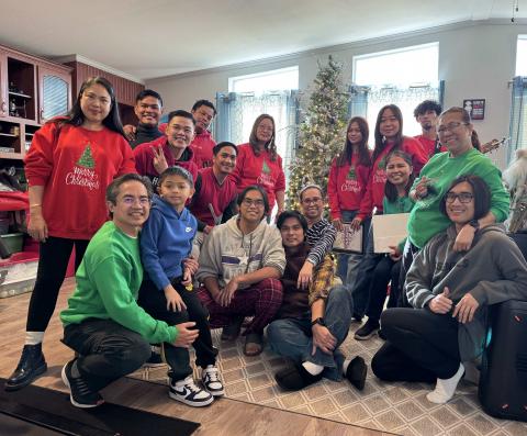 Mr. Garland and Mrs. Siela Rivera welcome carolers with warm smiles and Christmas colors. PHOTO – Courtesy