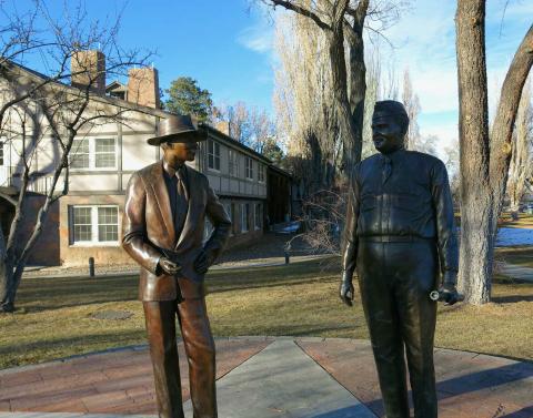 If only they could talk. Statues dedicated to the memory of J. Robert Oppenheimer and Gen. Leslie Richard Groves appear to share a moment of casual conversation in downtown Los Alamos, N.M., where the atomic age began. Photo by Kathy Helms