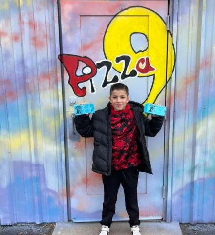 Maverik Garcia stands in front of the Pizza 9 building after the Mt. Taylor Quadrathlon. The locally owned pizzeria offered free pizzas to all the youth who participated in the 2025 Kids Quad. Thank you, Pizza 9 for supporting Cibola! Courtesy Photo
